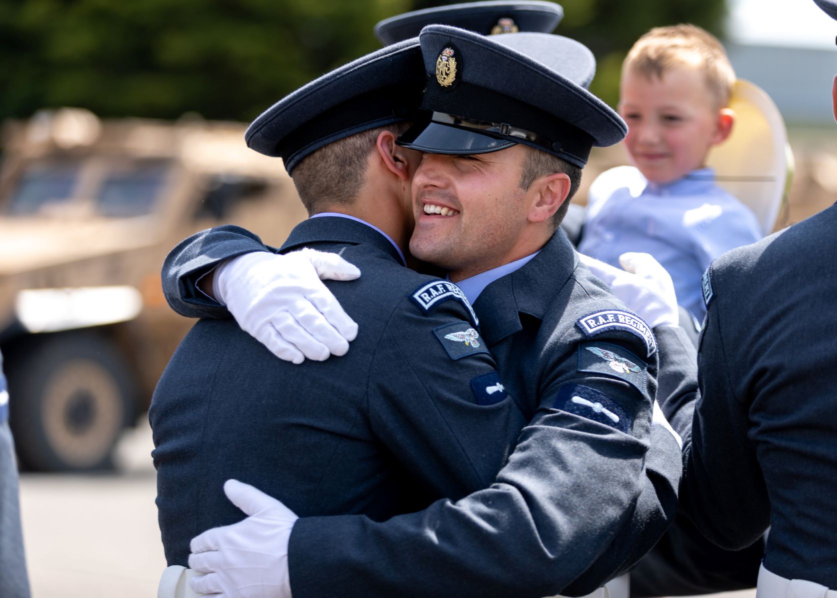 Aviators hug during graduation.